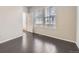 A bright bedroom with hardwood floors, a window and a door to an outdoor patio at 14176 Jackson St, Thornton, CO 80602