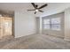 Carpeted bedroom featuring neutral colored walls, a ceiling fan, and a window at 14176 Jackson St, Thornton, CO 80602