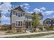 Well-kept home boasts gray siding and brick accents, complemented by a professionally landscaped front yard and lovely tree at 14176 Jackson St, Thornton, CO 80602