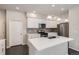Well-equipped kitchen with white cabinets, stainless steel appliances, and a functional center island at 14176 Jackson St, Thornton, CO 80602