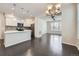 Bright, open kitchen with an island, modern stainless steel appliances, and adjacent dining and living areas at 14176 Jackson St, Thornton, CO 80602
