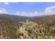 Breathtaking aerial view of a serene landscape featuring a river, valley, and lush forest at 2230 S Platte River Rd, Sedalia, CO 80135