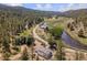 Scenic aerial view of a property nestled in a lush, mountainous landscape with a winding river at 2230 S Platte River Rd, Sedalia, CO 80135