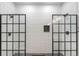 Modern bathroom featuring dual walk-in showers with glass doors, subway tile walls, and stone floors at 2230 S Platte River Rd, Sedalia, CO 80135