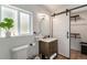 Well-lit bathroom showcases a sliding barn door, modern vanity, and ample natural light at 2230 S Platte River Rd, Sedalia, CO 80135