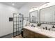 Modern bathroom with double vanity, sleek fixtures, and a glass-enclosed shower with subway tile at 2230 S Platte River Rd, Sedalia, CO 80135