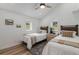 Bright bedroom with two twin beds, wood floors, and natural light from the windows at 2230 S Platte River Rd, Sedalia, CO 80135