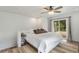 Bright bedroom with a bed, wood floors, a ceiling fan, and a sliding door to the balcony at 2230 S Platte River Rd, Sedalia, CO 80135