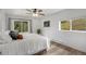 Serene bedroom with a bed, wood floors, a ceiling fan, and a sliding door to a deck at 2230 S Platte River Rd, Sedalia, CO 80135