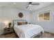 Comfortable bedroom with a bed, wood floors, a ceiling fan, and natural light from the window at 2230 S Platte River Rd, Sedalia, CO 80135