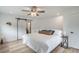 Stylish bedroom with a comfortable bed, wood floors, a ceiling fan, barn doors, and wood accent wall at 2230 S Platte River Rd, Sedalia, CO 80135