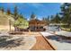 Charming home featuring a cozy patio, gravel landscaping, and a convenient two-car garage at 2230 S Platte River Rd, Sedalia, CO 80135