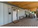 Charming front porch featuring a wooden bench and space for seating, ideal for enjoying the outdoors at 2230 S Platte River Rd, Sedalia, CO 80135