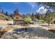 Inviting two-story home with a fire pit and lush landscaping, perfect for outdoor relaxation and entertaining at 2230 S Platte River Rd, Sedalia, CO 80135