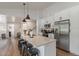 Stylish kitchen with stainless steel appliances, white cabinets, and island with barstool seating at 2230 S Platte River Rd, Sedalia, CO 80135