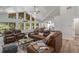 Spacious living room with large windows, a vaulted ceiling, and comfortable leather furniture at 2230 S Platte River Rd, Sedalia, CO 80135