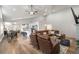 Spacious living room with a leather sectional sofa, hardwood floors, adjacent to the kitchen and dining area at 2230 S Platte River Rd, Sedalia, CO 80135