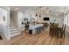 Open-concept kitchen and living area with modern appliances, a large island, and stairs to the second floor at 2230 S Platte River Rd, Sedalia, CO 80135