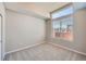 Well-lit bedroom featuring a large window, neutral walls, and carpeted floor at 9627 Browns Peak Cir, Littleton, CO 80125