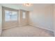 Bright bedroom featuring neutral walls, carpeted floor, and windows with blinds at 9627 Browns Peak Cir, Littleton, CO 80125