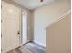 Bright entryway featuring sleek gray flooring, a large window, and a white door at 9627 Browns Peak Cir, Littleton, CO 80125