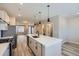 Well-lit kitchen with an island sink, stainless appliances, and stylish pendant lighting at 9627 Browns Peak Cir, Littleton, CO 80125