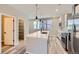 Bright kitchen boasts stainless appliances, large center island with sink, and stylish pendant lighting at 9627 Browns Peak Cir, Littleton, CO 80125