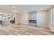 Open-concept living room flowing into modern kitchen with stainless steel appliances at 9627 Browns Peak Cir, Littleton, CO 80125