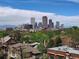 Scenic daytime cityscape of Denver with mountain views, lush trees, and building rooftops at 1085 N Lafayette St # 704, Denver, CO 80218