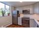 Well-lit kitchen featuring stainless steel appliances, neutral cabinetry, and a view from the window at 1085 N Lafayette St # 704, Denver, CO 80218