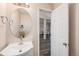 Well-lit half bathroom with modern vanity and fixtures at 13421 Humboldt Way, Thornton, CO 80241