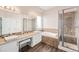 Bright bathroom featuring double sinks, a soaking tub and a separate shower with tile surround at 13421 Humboldt Way, Thornton, CO 80241