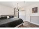 Bedroom featuring wood floors, a modern light fixture and neutral decor at 13421 Humboldt Way, Thornton, CO 80241