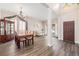 Open-concept dining area showcasing a wooden table, elegant chandelier, and a bright and airy ambiance at 13421 Humboldt Way, Thornton, CO 80241