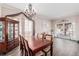 Dining area featuring a large wooden table, ornate chandelier, and ample natural light at 13421 Humboldt Way, Thornton, CO 80241