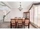 Dining room featuring a modern chandelier, ample seating, and elegant decor at 13421 Humboldt Way, Thornton, CO 80241