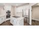 Updated kitchen featuring stainless appliances, quartz countertops, and large island with cooktop at 13421 Humboldt Way, Thornton, CO 80241