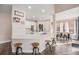 Bright, open kitchen with stainless appliances, quartz countertops, island with seating, and a breakfast nook at 13421 Humboldt Way, Thornton, CO 80241