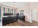 The main bedroom features a large bed, dark furniture, and a bay window at 13421 Humboldt Way, Thornton, CO 80241
