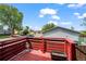 The back deck area with red wood, a small statue, a green tree and a view of the neighborhood at 5338 Granby St, Denver, CO 80239