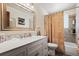 Bright bathroom with marble countertop vanity, tub, and decorative shower curtain at 5338 Granby St, Denver, CO 80239