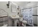 Charming bathroom features a pedestal sink, decorative mirror and tiled floor at 5338 Granby St, Denver, CO 80239