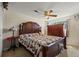 Spacious bedroom with a large bed, a wooden dresser, a ceiling fan and bright, natural lighting at 5338 Granby St, Denver, CO 80239