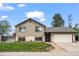Inviting two-story home with attached garage, manicured lawn, and charming brick accents at 5338 Granby St, Denver, CO 80239
