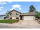 Inviting two-story home with attached garage, manicured lawn, and charming brick accents at 5338 Granby St, Denver, CO 80239