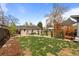 Spacious backyard with shade structure, landscaping, and well maintained lawn at 3368 S Corona St, Englewood, CO 80113