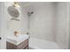 Modern bathroom features tiled shower and bathtub with vanity and lighted mirror at 3368 S Corona St, Englewood, CO 80113