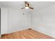 Bright bedroom features hardwood floors, white walls, and built-in cabinets at 3368 S Corona St, Englewood, CO 80113