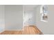 Bright bedroom features hardwood floors, white walls, a window, and closet at 3368 S Corona St, Englewood, CO 80113