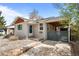 Charming single-story home featuring stone landscaping, covered patio, and private gated parking area at 3368 S Corona St, Englewood, CO 80113